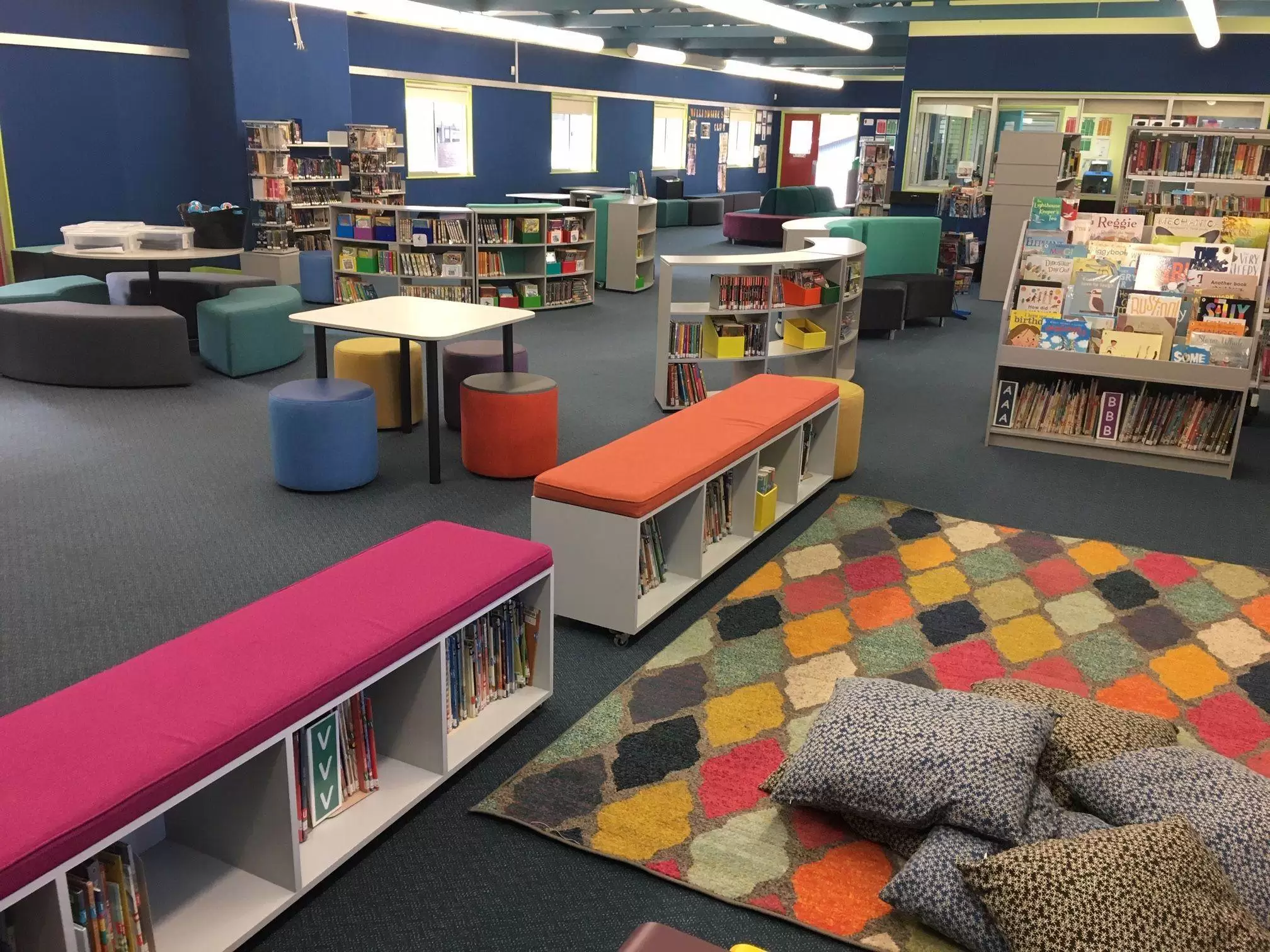 Primary school library with tables lounges and book cases